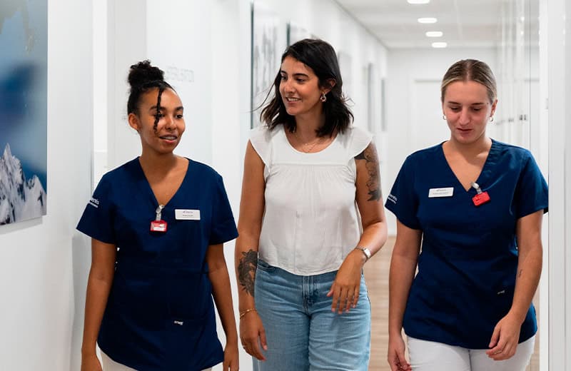 Friendly Ardentis dental team with patients in a bright, modern clinic, showcasing professional dental care and patient comfort.