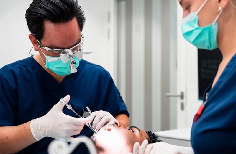 Dentiste traitant une carie sur une dent d’un patient