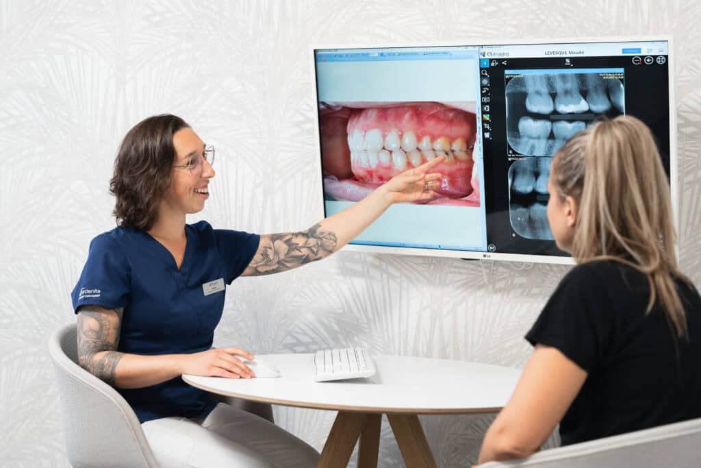 Dental consultation with a dentist explaining oral health and X-ray images to a patient.